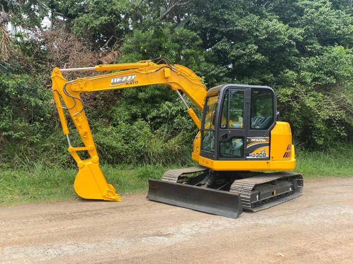 A yellow construction vehicle on a dirt road