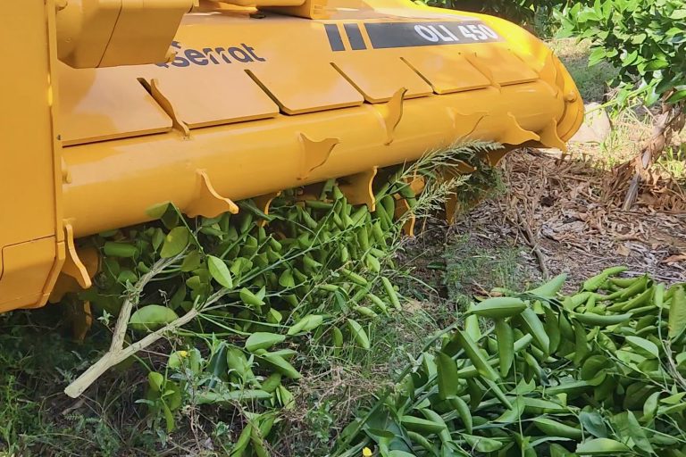 a yellow machine with green leaves