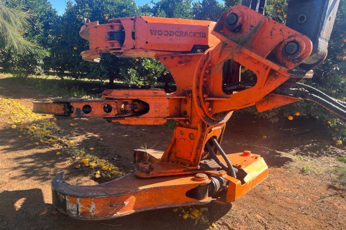 An orange machine with a large arm